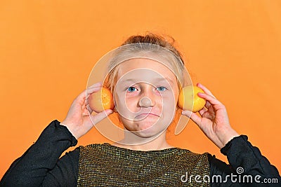 The boy plays the clarinet in the girlâ€™s ear, the outraged girl waves her arms Stock Photo